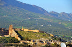 Riad Dar Tahri SPA view of historic stone fortress walls and traditional buildings set against green mountainous landscape