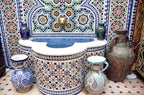 Riad Dar Tahri SPA Moroccan-style mosaic fountain with colorful geometric tile patterns and traditional ceramic pots around it