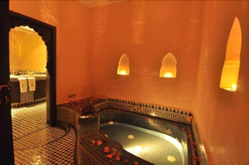 Riad Salam Fes Moroccan style tiled spa bath with warm lighting and decorative wall niches