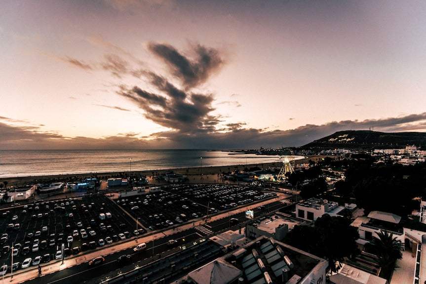 Royal Mirage Agadir coastal cityscape overlooking Agadir beach, Atlantic Ocean, marina and hillside at sunset