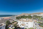Royal Mirage Agadir coastal hotel area with white buildings, palm trees, sandy beach and Atlantic Ocean
