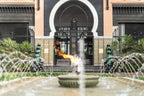 Sofitel Marrakech Palais Imperial & Spa entrance with Moroccan architectural details, decorative tiles, ornate archway, and central fountain with flame