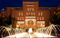 Sofitel Marrakech Palais Imperial & Spa luxury hotel building illuminated at night with arched entrance and water fountains in front