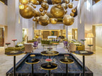 Luxury hotel lobby at Sofitel Marrakech Palais Imperial & Spa featuring hanging golden spherical lights, modern seating, and elegant decor