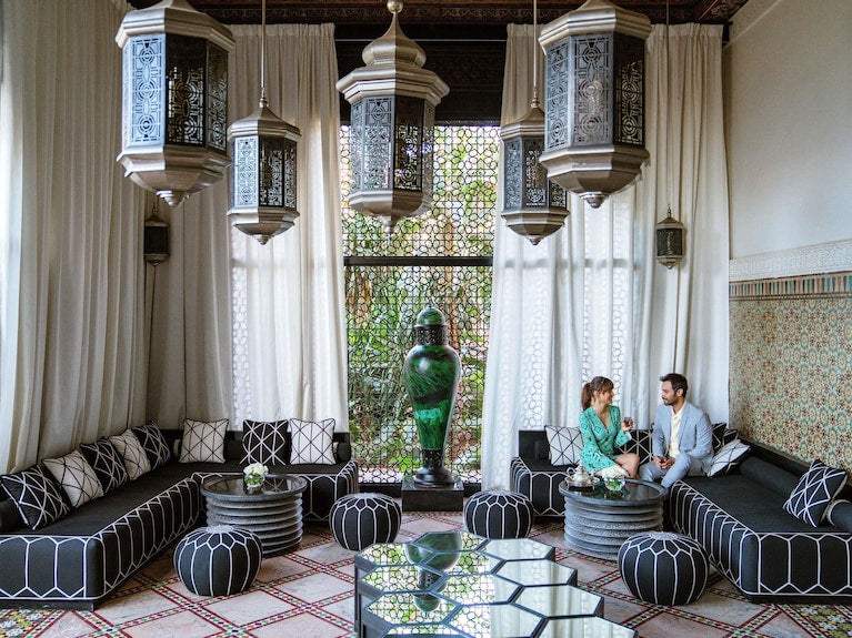 Sofitel Marrakech Palais Imperial & Spa seating area with black and white patterned cushions, Moroccan lanterns, and decorative tiles