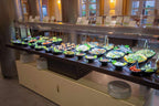 Buffet salad bar at Timoulay Hotel & Spa Agadir with assorted fresh vegetables and salads in black bowls on a dark wooden counter