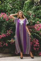 Purple cotton traditional Moroccan kaftan with multicolored vertical stripes and white silk embroidery on the neckline and sleeves.