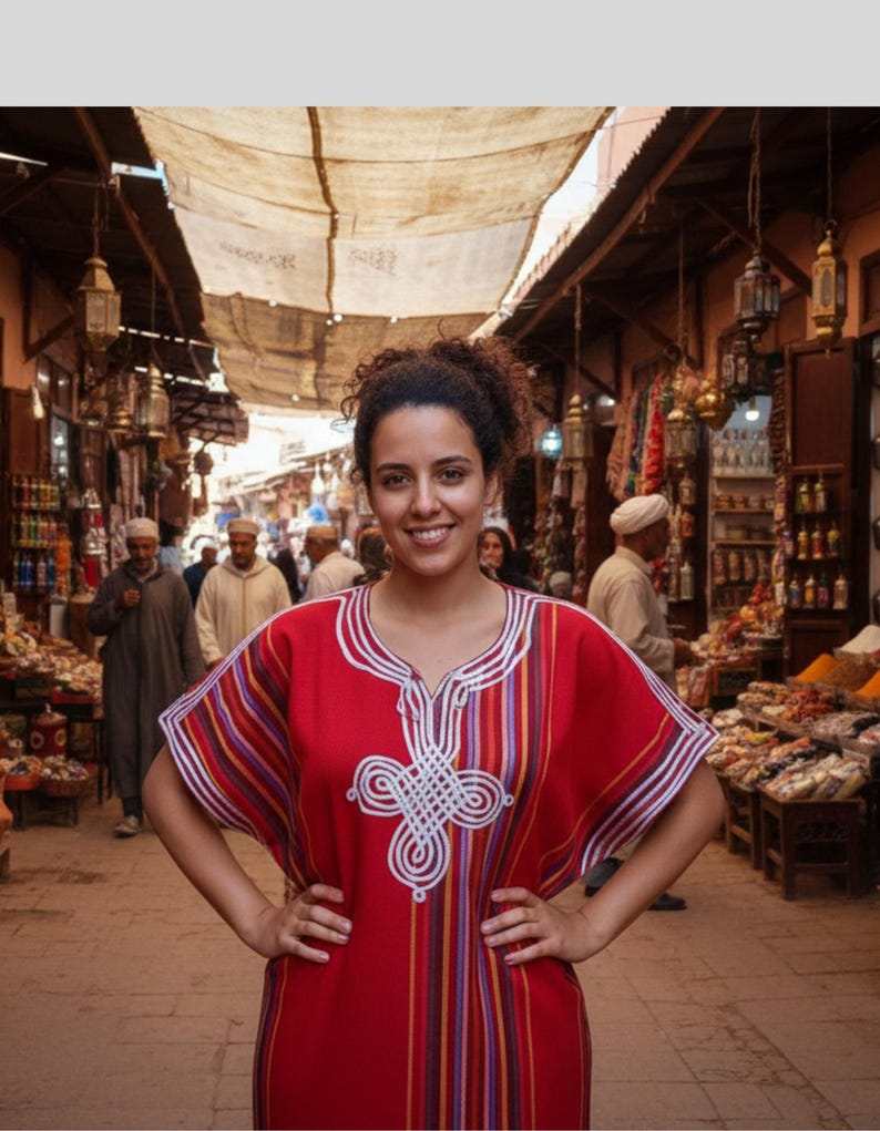 traditional Moroccan kaftan in red cotton with multicolored vertical stripes and white silk embroidery on the front neckline and chest area